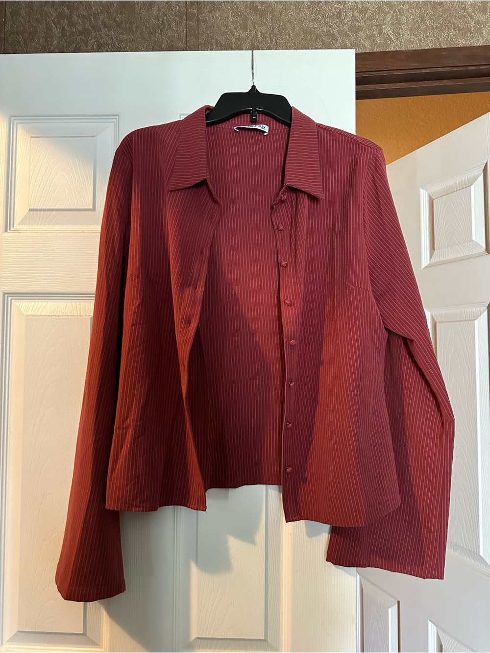 Princess Polly striped blouse with bell sleeves.